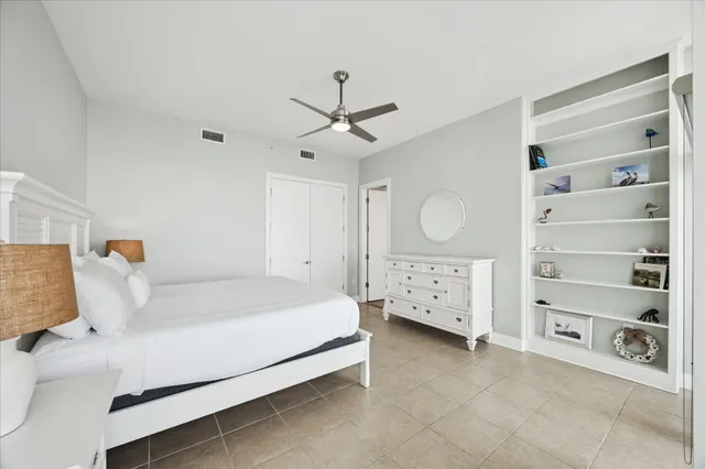 a bedroom with a bed a window and a chandelier