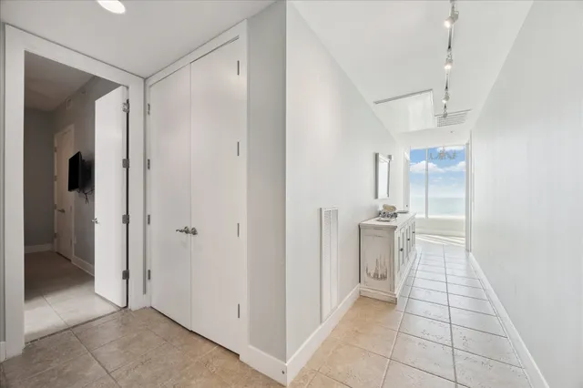 a view of a walk in closet and a bathroom