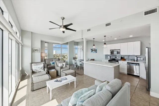 a living room with furniture kitchen view and a refrigerator