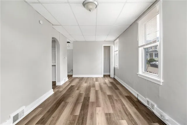 a view of a livingroom with wooden floor and a window
