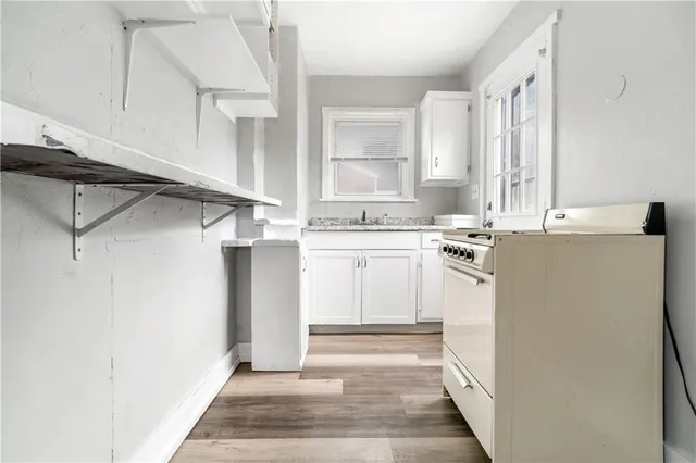 a utility room with cabinets washer and dryer