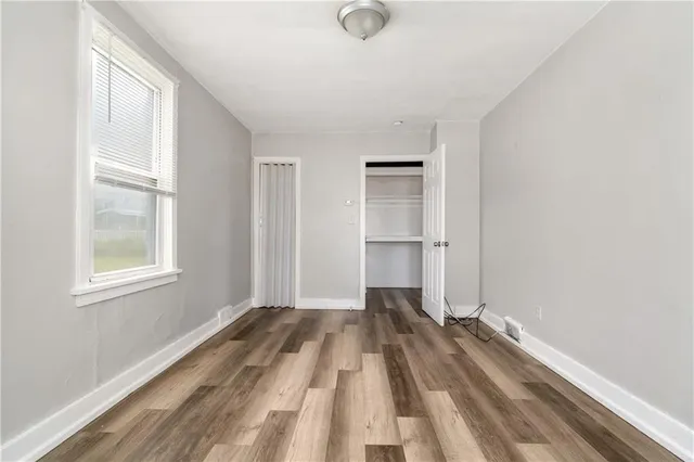 a view of a room with wooden floor and windows