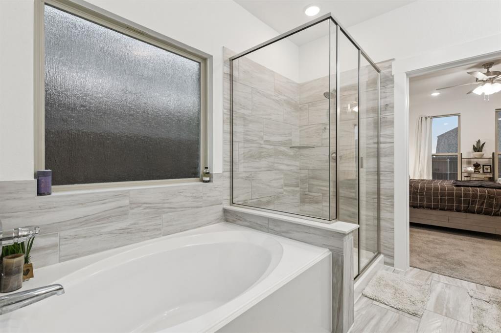 1238 Beaumont Lane Red Oak, TX 75154 - Photo 14 of 29 a bathroom with a bathtub and a shower