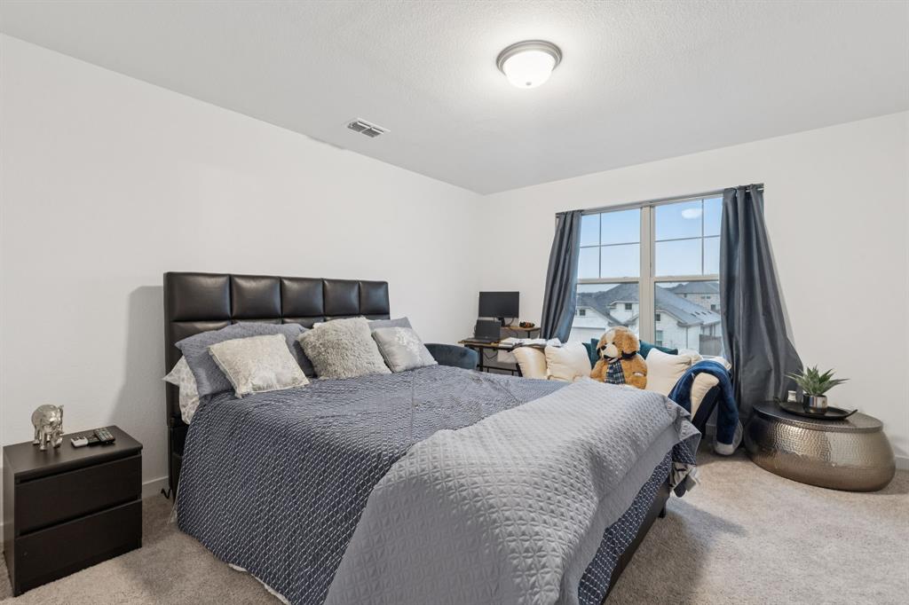 1238 Beaumont Lane Red Oak, TX 75154 - Photo 16 of 29 a bed room with a bed and a couch