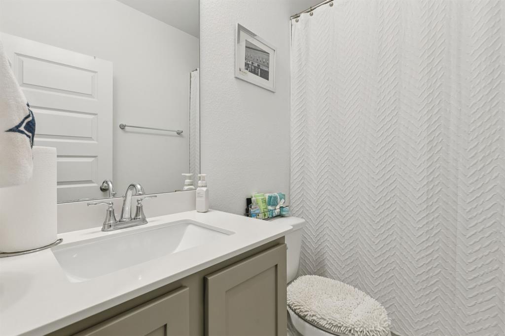 1238 Beaumont Lane Red Oak, TX 75154 - Photo 17 of 29 a bathroom with a sink a toilet and a mirror