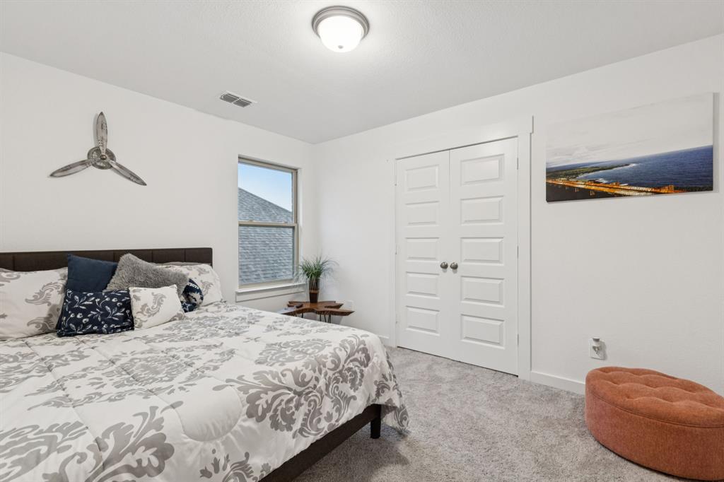 1238 Beaumont Lane Red Oak, TX 75154 - Photo 18 of 29 a bedroom with a bed and a window