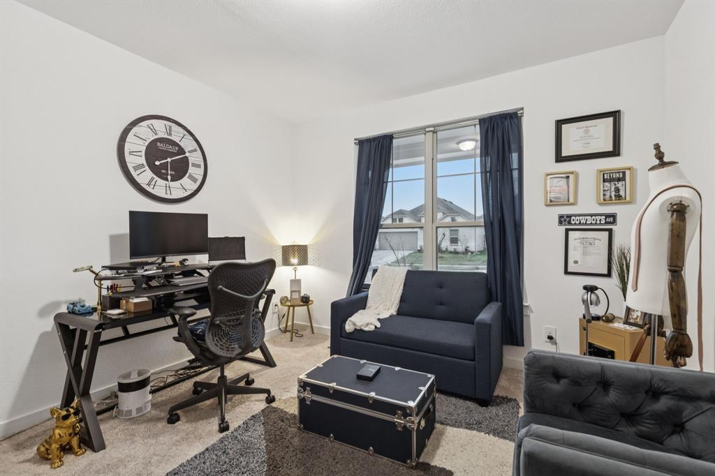 1238 Beaumont Lane Red Oak, TX 75154 - Photo 20 of 29 a living room with furniture a clock on the wall and a window