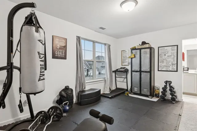 a view of a livingroom with workspace and a window