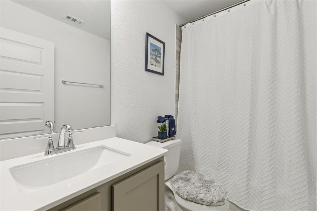 1238 Beaumont Lane Red Oak, TX 75154 - Photo 23 of 29 a bathroom with a sink toilet and vanity