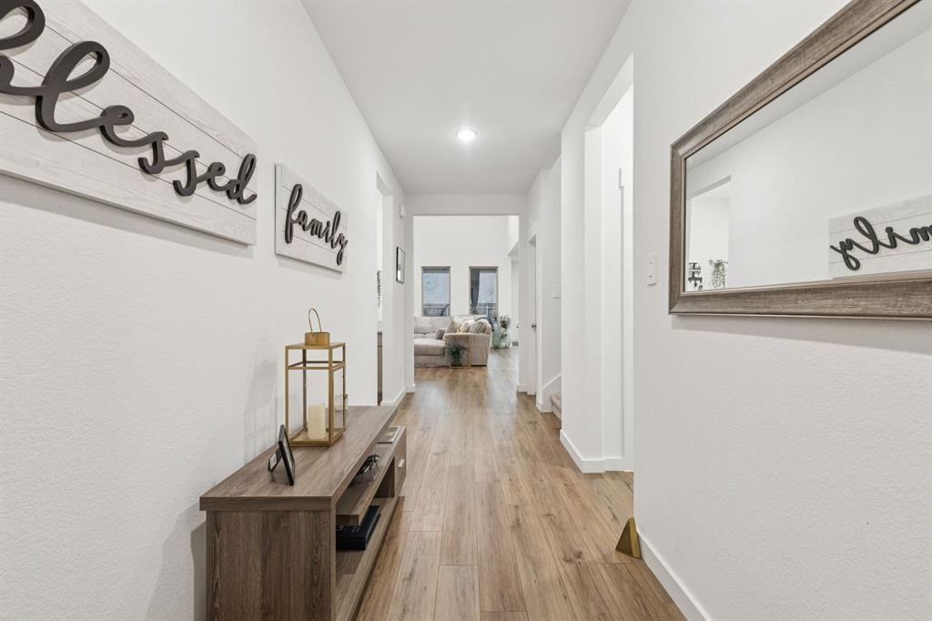 1238 Beaumont Lane Red Oak, TX 75154 - Photo 3 of 29 a view of a hallway with wooden floor and staircase