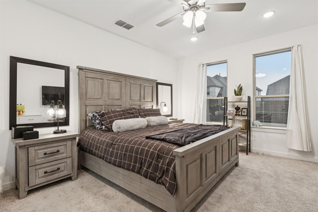 1238 Beaumont Lane Red Oak, TX 75154 - Photo 10 of 29 a bedroom with a bed kitchen view and a window