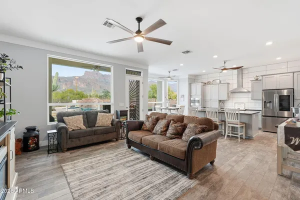 a view of kitchen with refrigerator a dining table and chairs