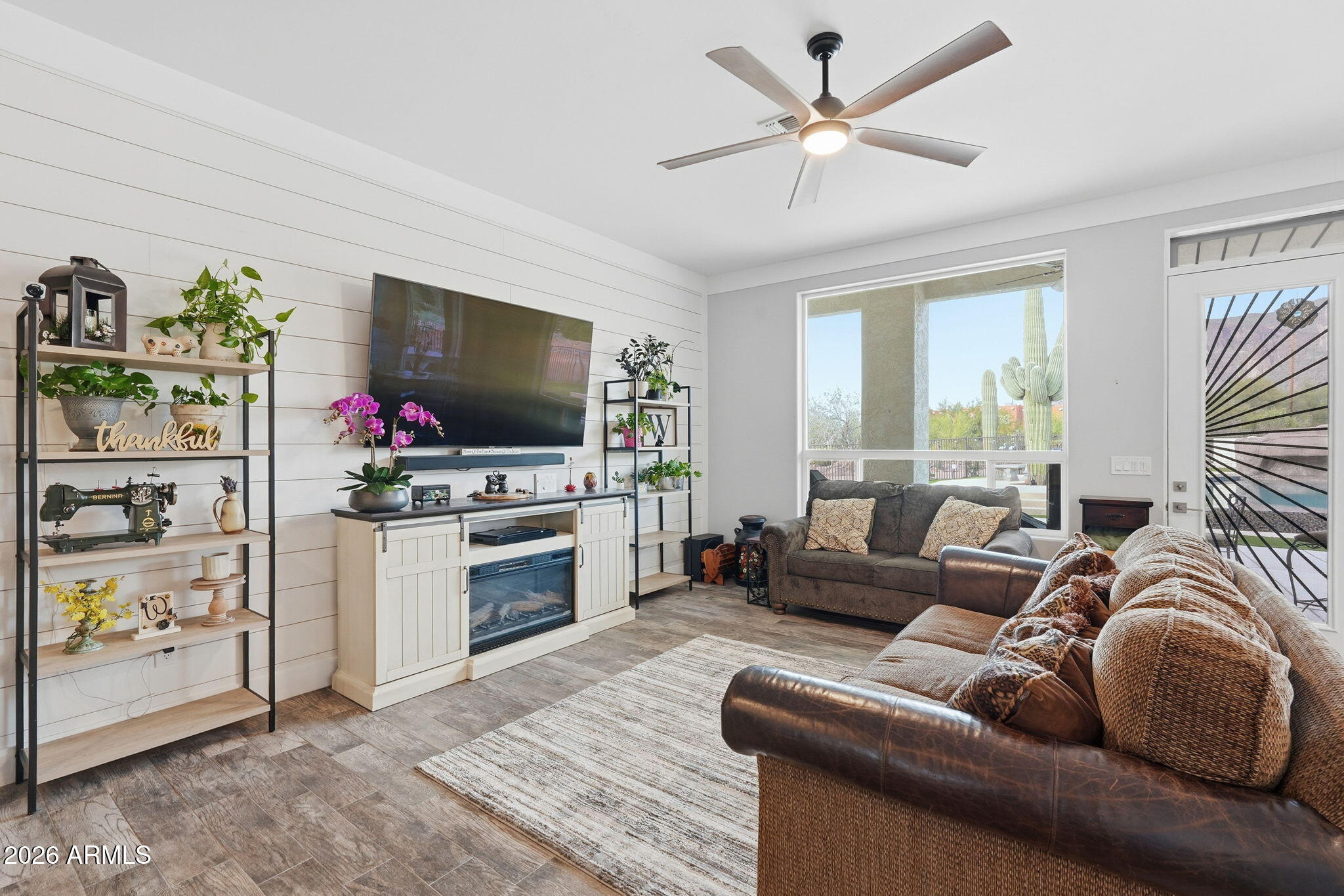 1067 South Trigger Court Apache Junction, AZ 85119 - Photo 14 of 60 a living room with furniture a flat screen tv and a fireplace