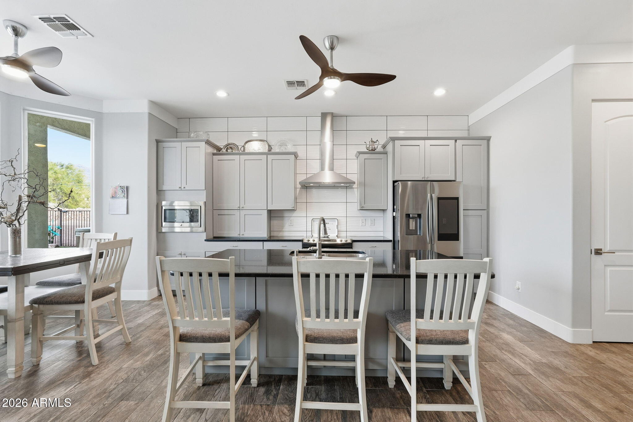 1067 South Trigger Court Apache Junction, AZ 85119 - Photo 18 of 60 a view of kitchen with refrigerator a dining table and chairs