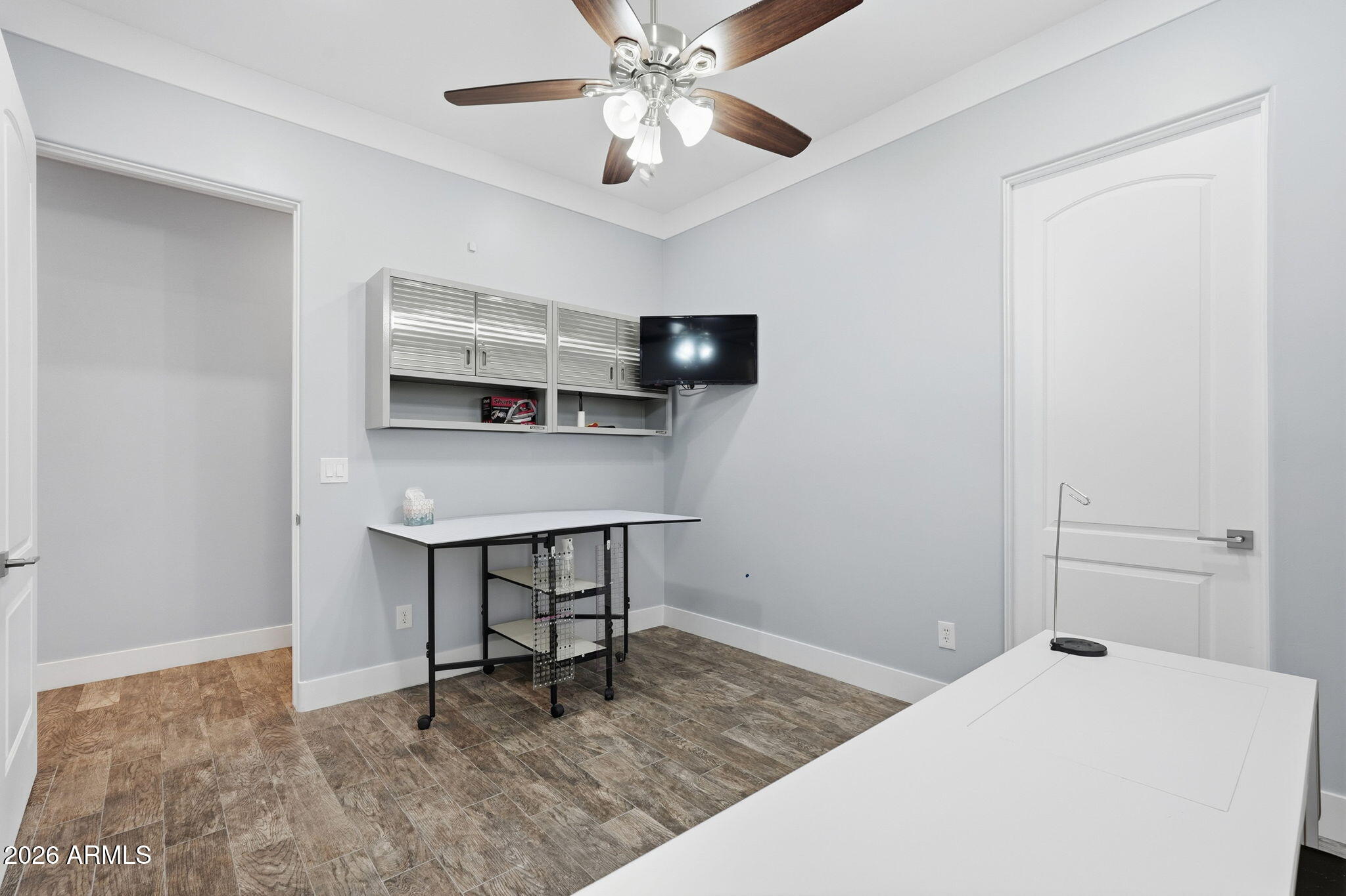 1067 South Trigger Court Apache Junction, AZ 85119 - Photo 26 of 60 a bedroom with a bed and a chandelier