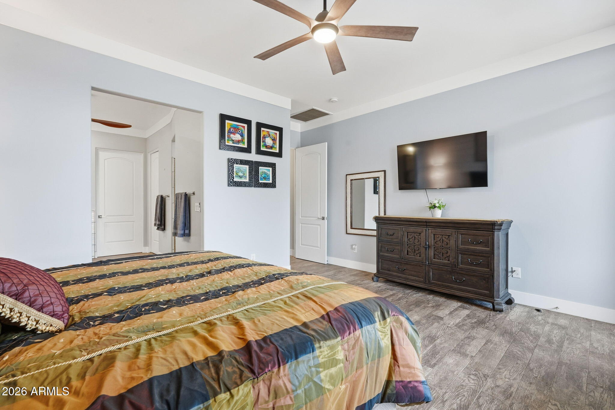 1067 South Trigger Court Apache Junction, AZ 85119 - Photo 29 of 60 a bedroom with a bed and a flat screen tv