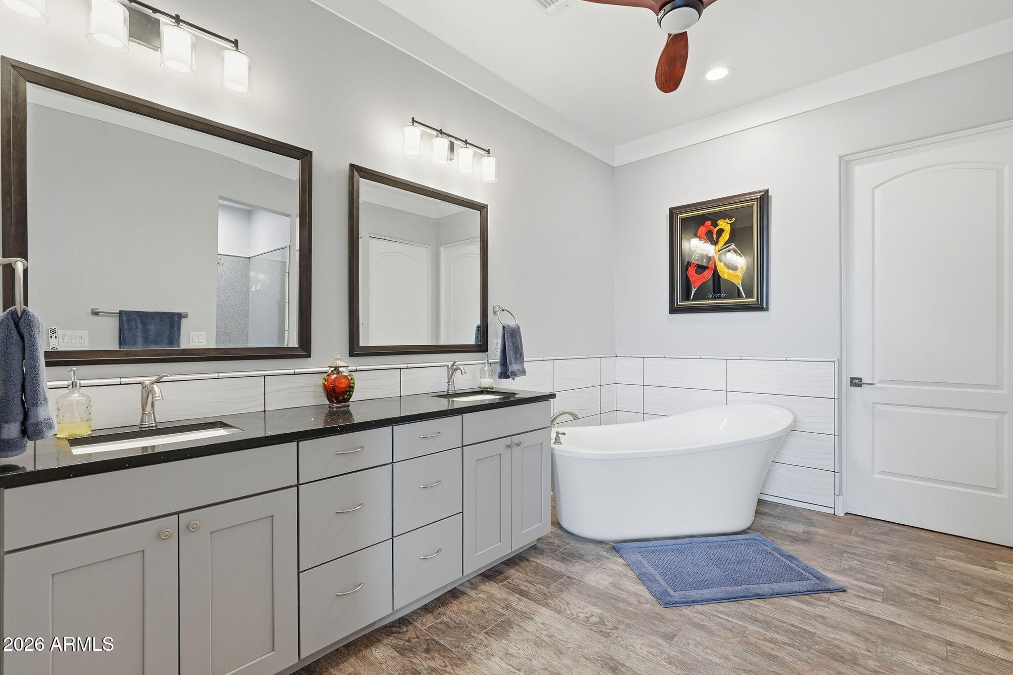 1067 South Trigger Court Apache Junction, AZ 85119 - Photo 36 of 60 a bathroom with a double vanity sink a mirror and a bathtub