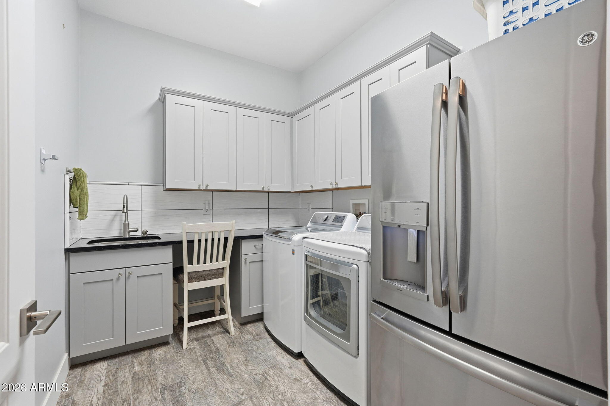 1067 South Trigger Court Apache Junction, AZ 85119 - Photo 39 of 60 a kitchen with stainless steel appliances a stove a sink and white cabinets
