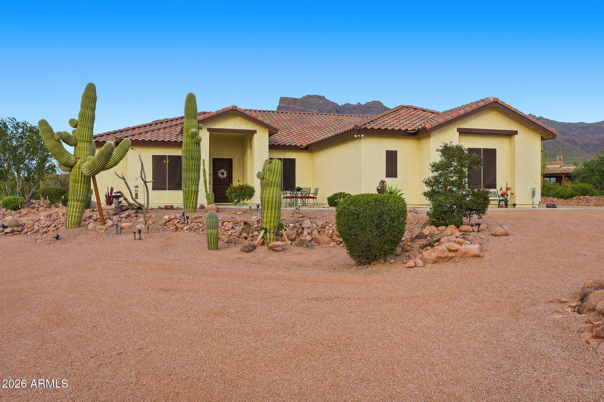 1067 South Trigger Court Apache Junction, AZ 85119 - Photo 5 of 60 a front view of a house with garden