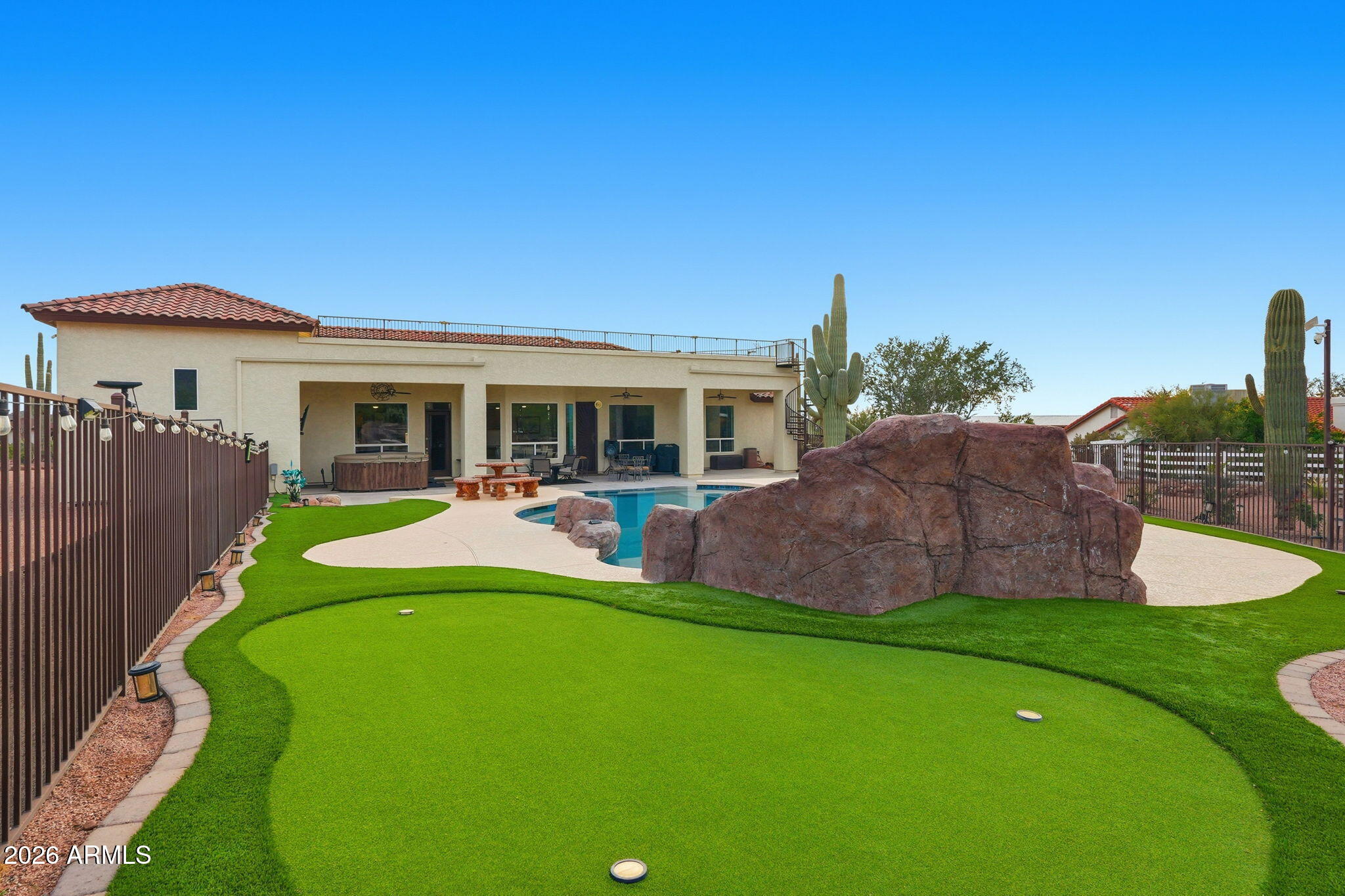 1067 South Trigger Court Apache Junction, AZ 85119 - Photo 54 of 60 a view of a house with a backyard and a patio