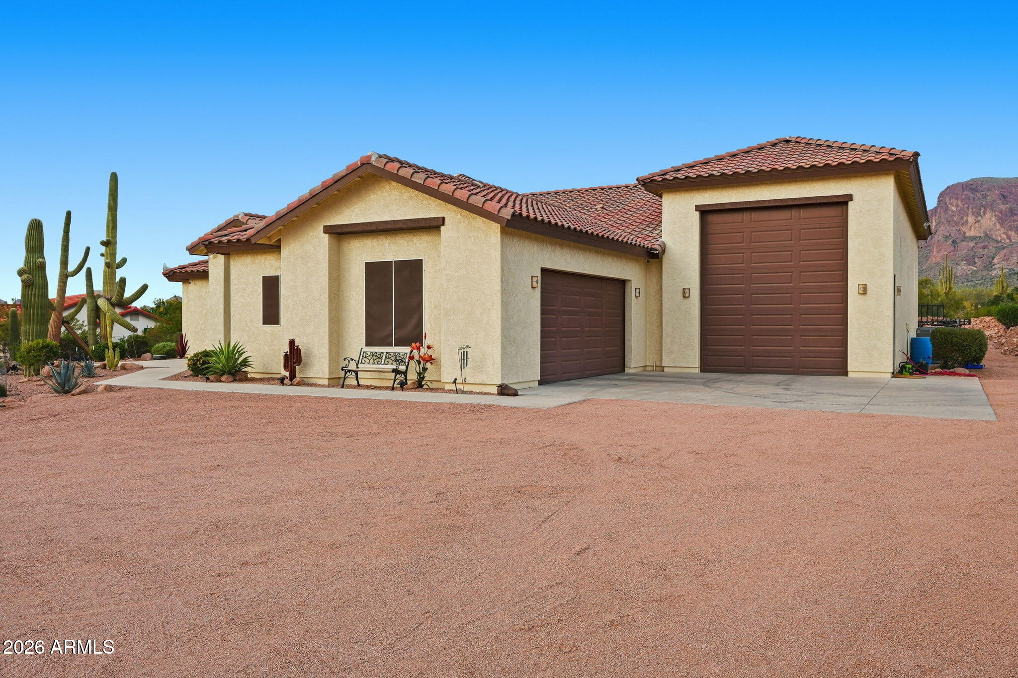 1067 South Trigger Court Apache Junction, AZ 85119 - Photo 6 of 60 a view of a house with a yard and garage