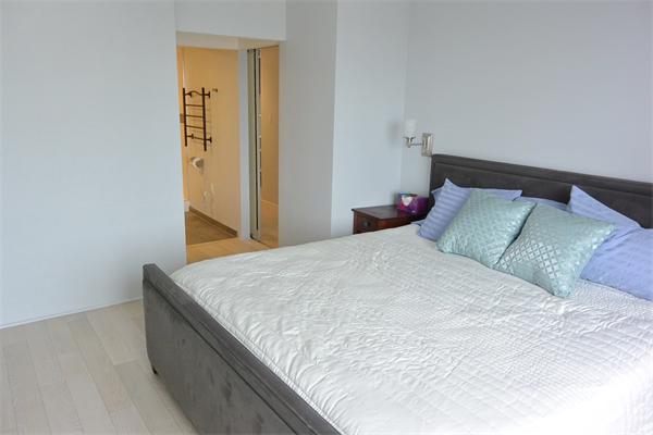 8 Museum Way, Unit 1201 Cambridge, MA 02141 - Photo 8 of 25 a bedroom with a bed and wooden floor