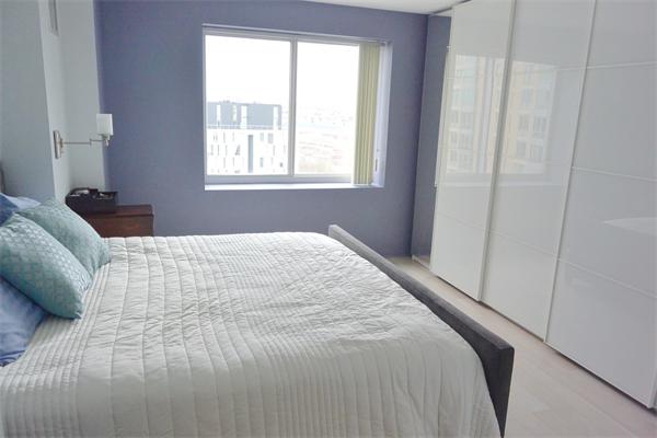 8 Museum Way, Unit 1201 Cambridge, MA 02141 - Photo 9 of 25 a bedroom with a bed and a window