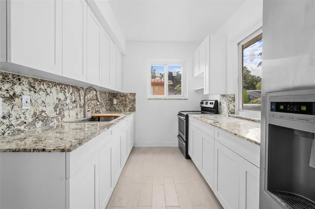 a kitchen with a sink and cabinets