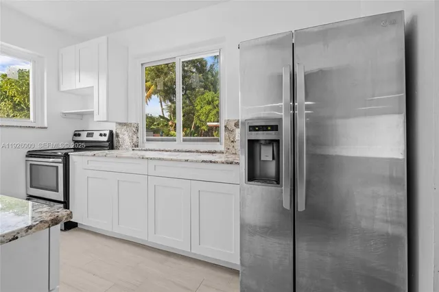 a kitchen with a refrigerator stove and sink