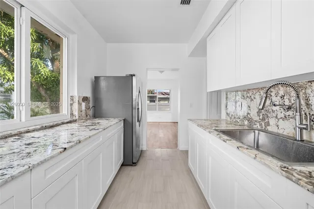 an empty room with wooden floor and a window