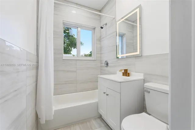 a view of a white house with a yard