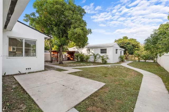 a view of empty room with a fireplace and wooden floor