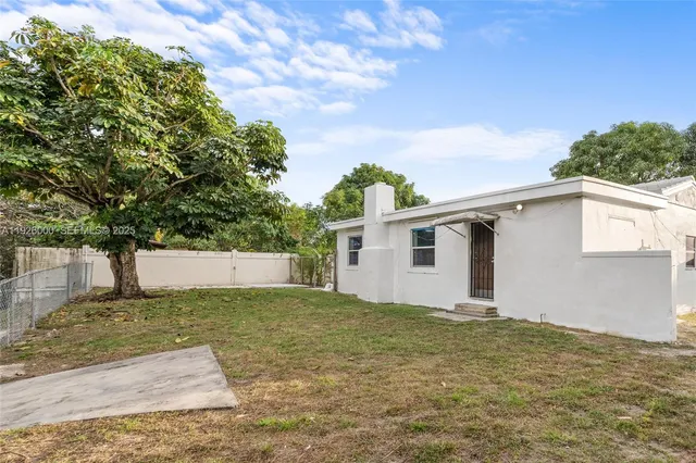 a kitchen with stainless steel appliances a refrigerator sink and white cabinets