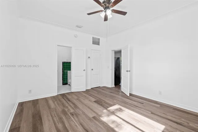 wooden floor in an empty room with a window