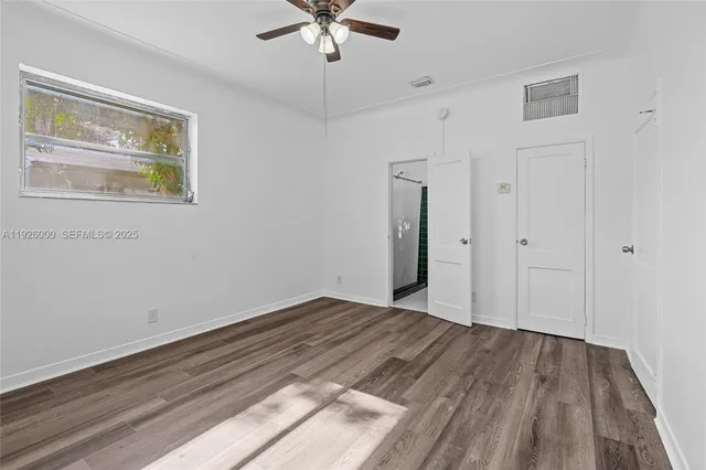 wooden floor in an empty room with a window