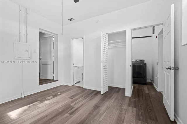 an aerial view of residential houses with outdoor space and trees