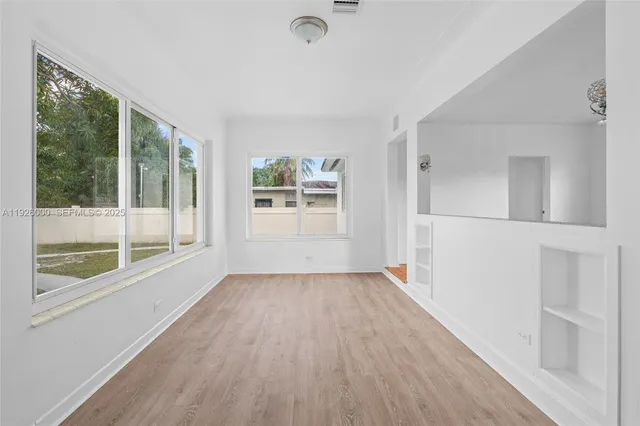 wooden floor in an empty room with a window