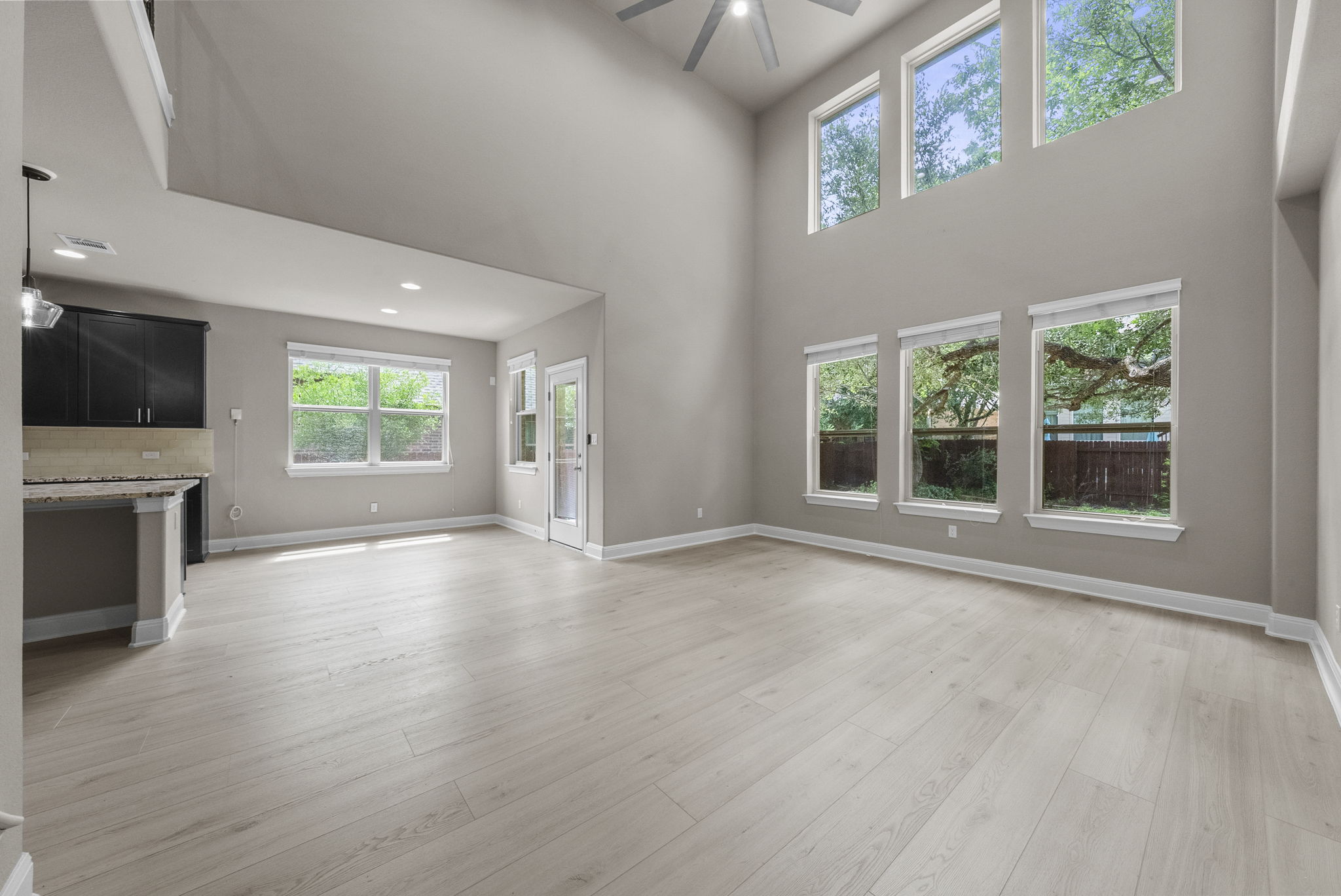 4401 Trinity Woods Street Leander, TX 78641 - Photo 15 of 37 Tall ceilings and abundant natural light create an inviting atmosphere in this open living area.