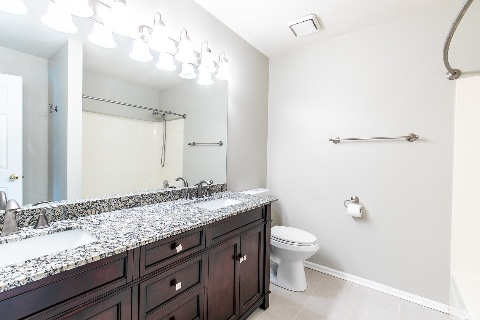 559 Cross Road Gurnee, IL 60031 - Photo 15 of 27 a bathroom with a granite countertop sink a toilet and a mirror