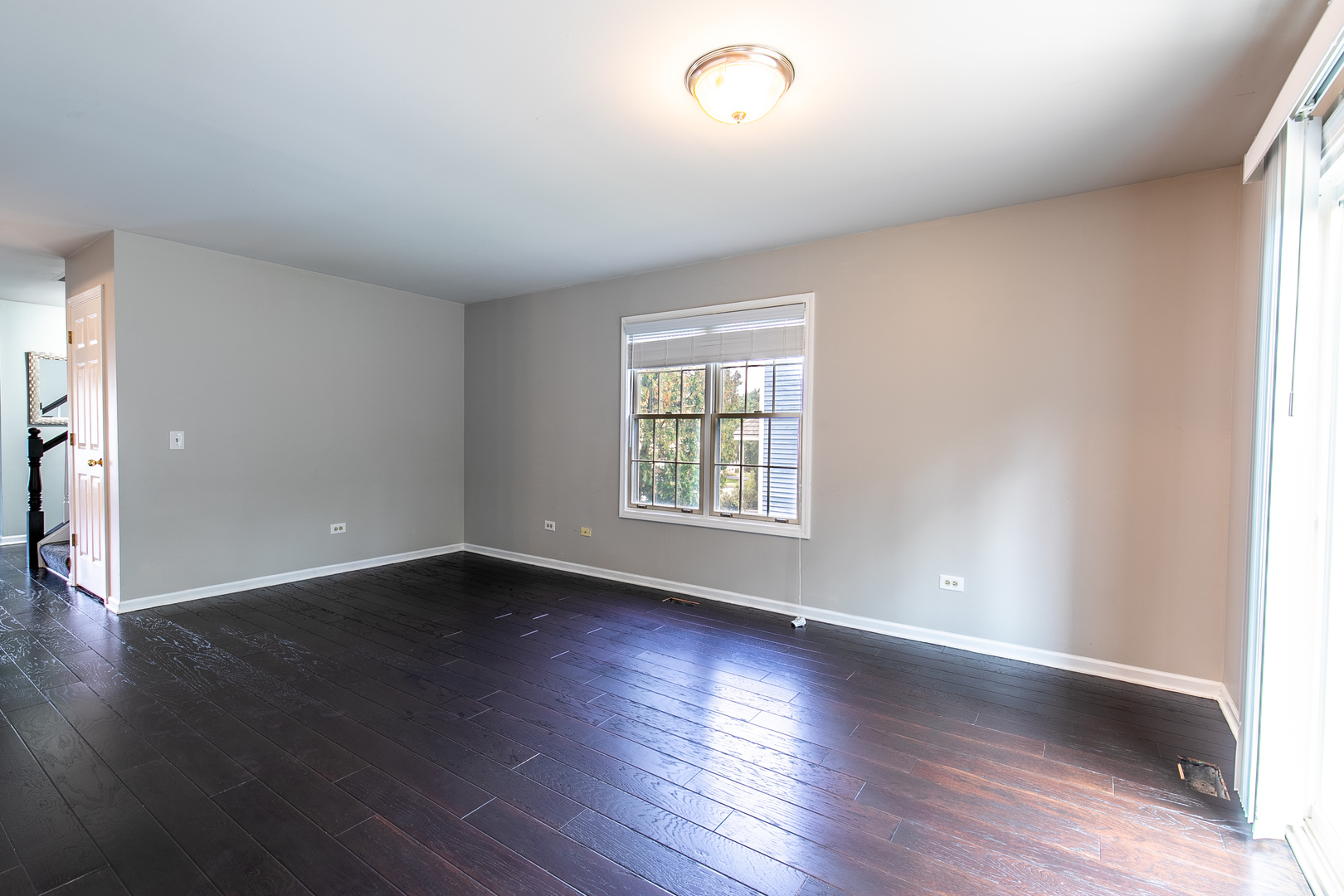 559 Cross Road Gurnee, IL 60031 - Photo 6 of 27 an empty room with wooden floor and windows