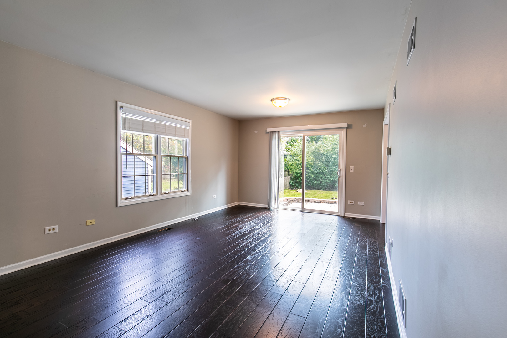 559 Cross Road Gurnee, IL 60031 - Photo 8 of 27 an empty room with wooden floor and windows