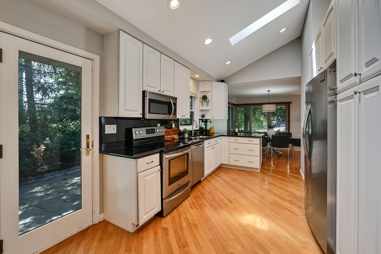 545 Highland Road Hinsdale, IL 60521 - Photo 9 of 29 a kitchen with granite countertop a stove a sink and a refrigerator