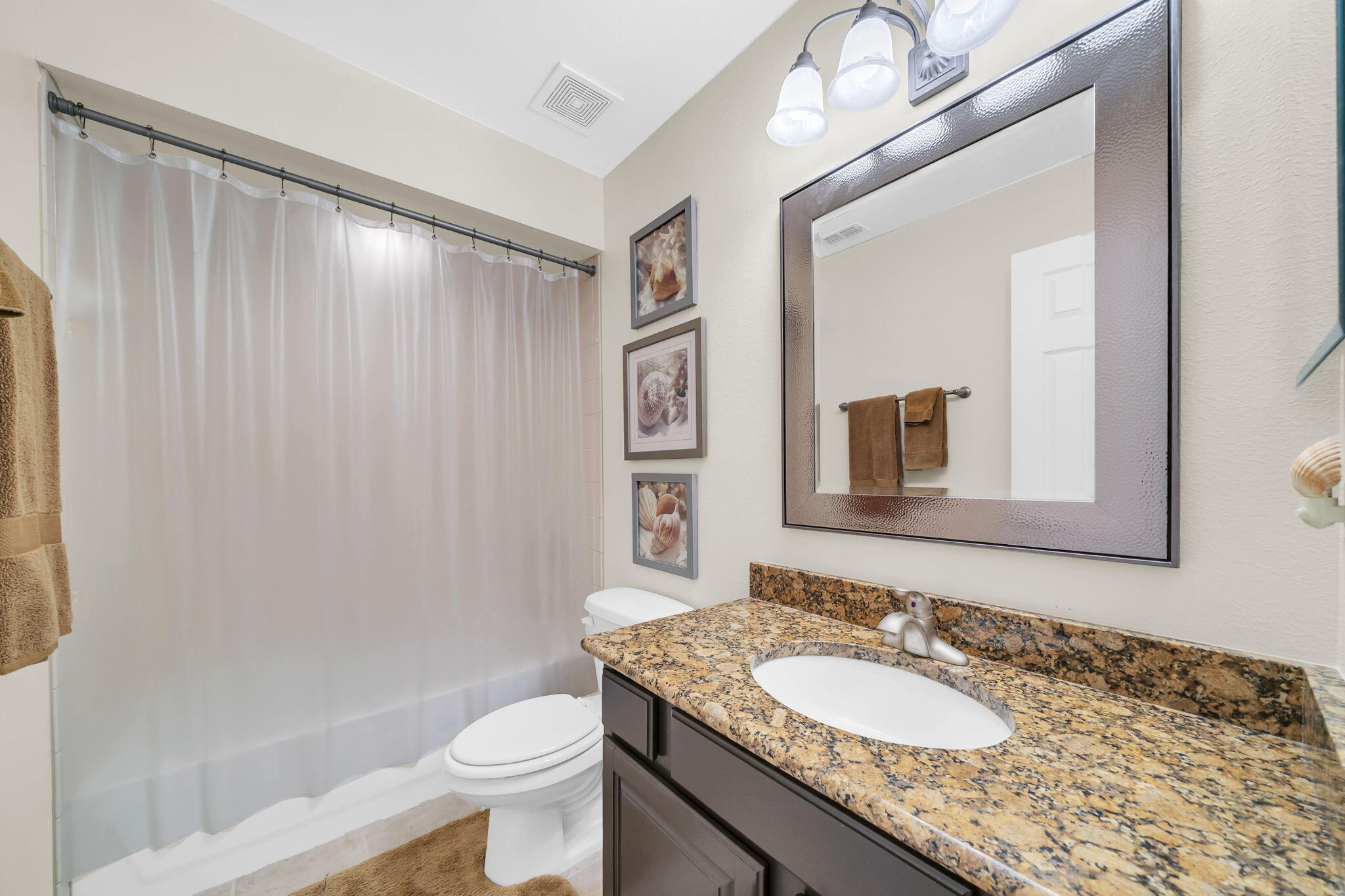 159 Golden Eagle Court, Unit 3C Santa Rosa Beach, FL 32459 - Photo 31 of 34 a bathroom with a granite countertop sink a toilet and a mirror