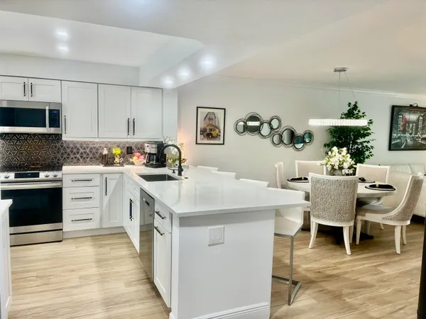 a kitchen with a sink cabinets and wooden floor