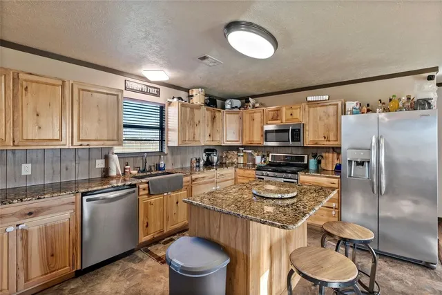a kitchen with stainless steel appliances granite countertop a stove and a microwave