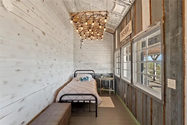 a spacious bedroom with furniture and a large window