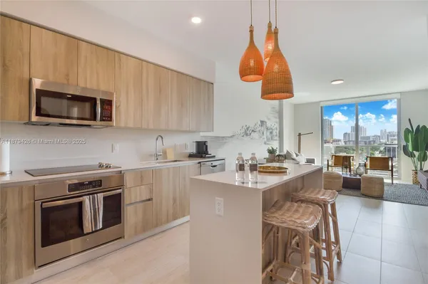 a kitchen with a stove a sink and a microwave