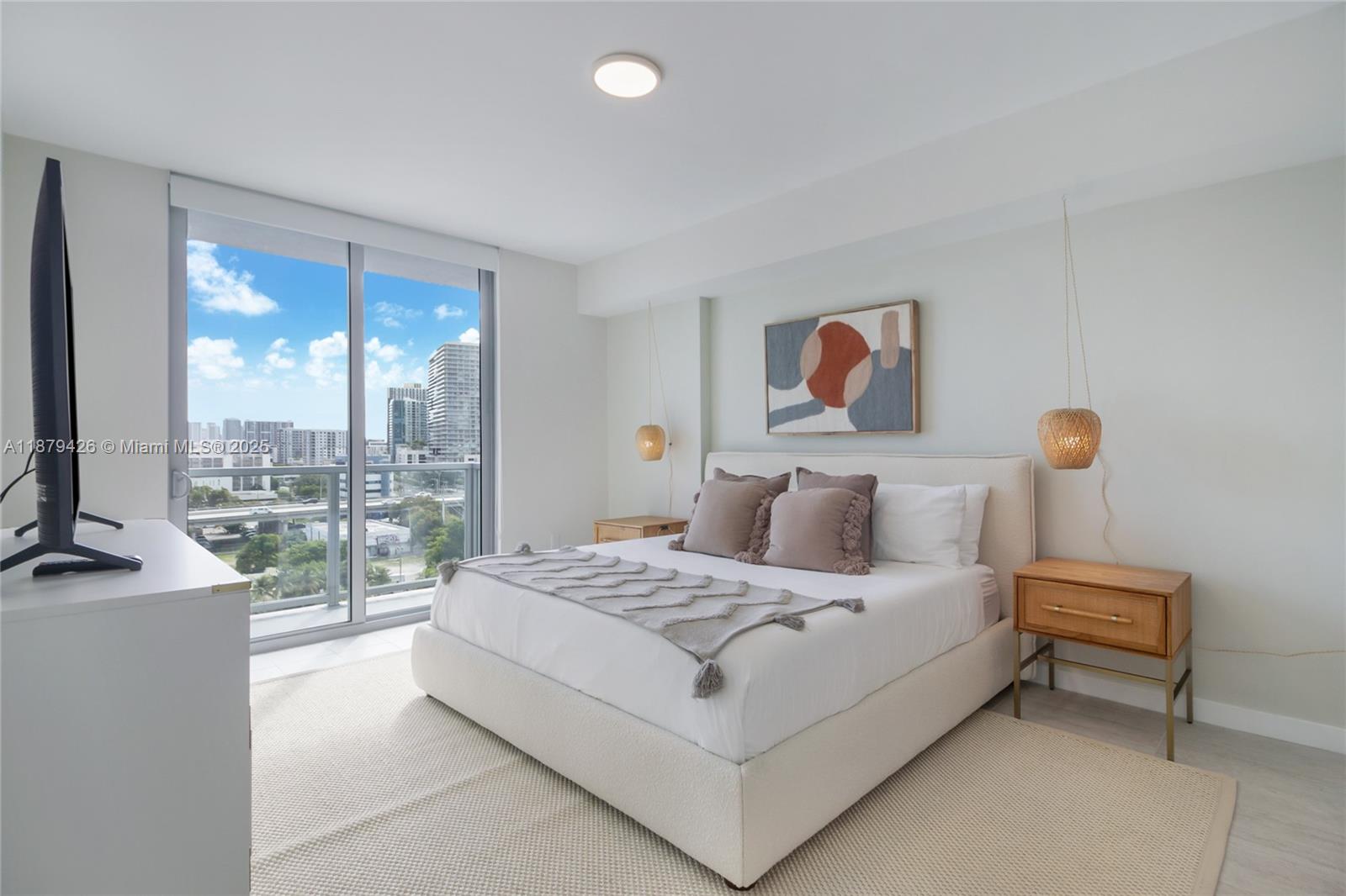 3900 Biscayne Boulevard, Unit S804 Miami, FL 33137 - Photo 6 of 36 a bedroom with a bed and a large window