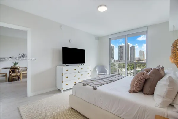 a bedroom with a bed and a flat screen tv