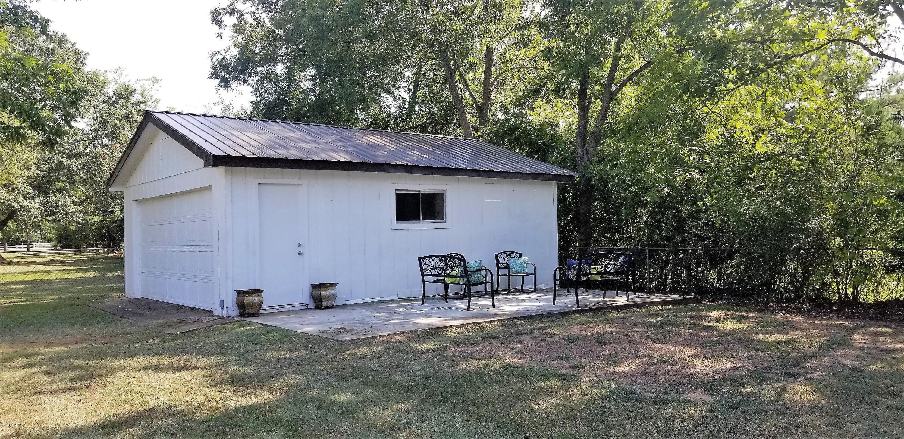 6609 Vinson Road Macon, GA 31216 - Photo 14 of 22 a backyard of a house with table and chairs
